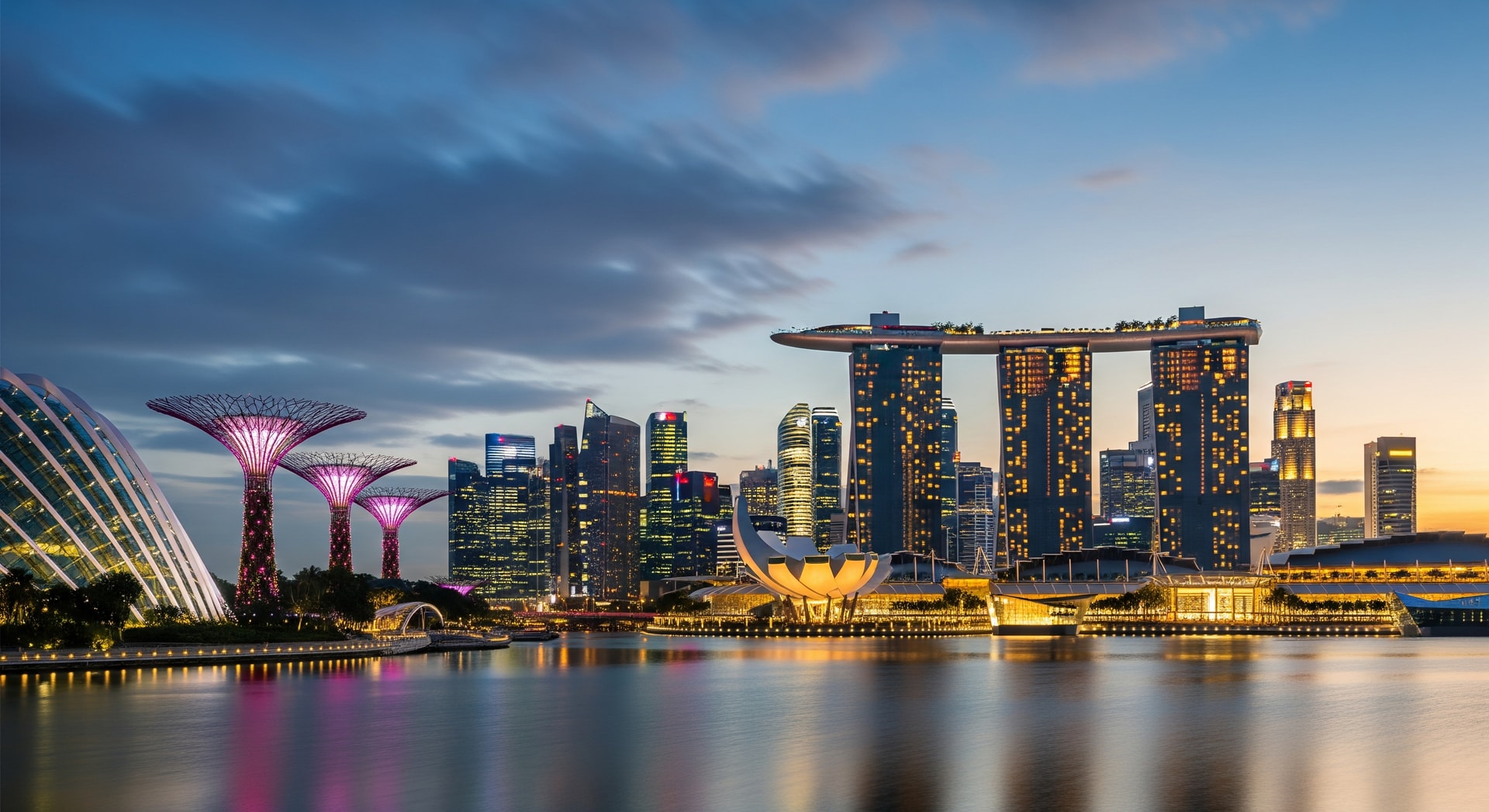 Marina Bay Sands and Singapore skyline at night with Gardens by the Bay