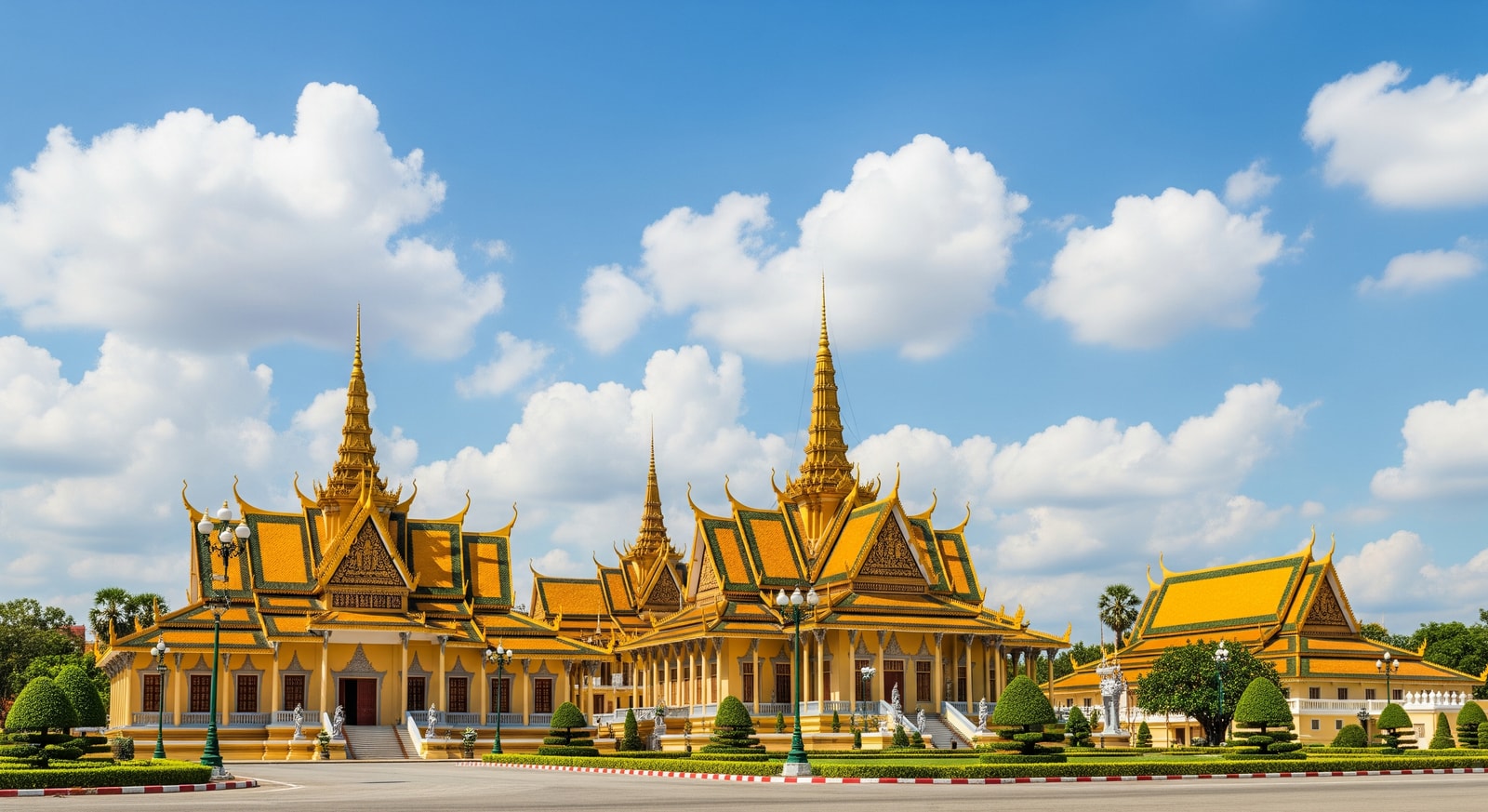 Golden spires of the Royal Palace in Phnom Penh gleaming under blue sky with traditional Khmer architecture