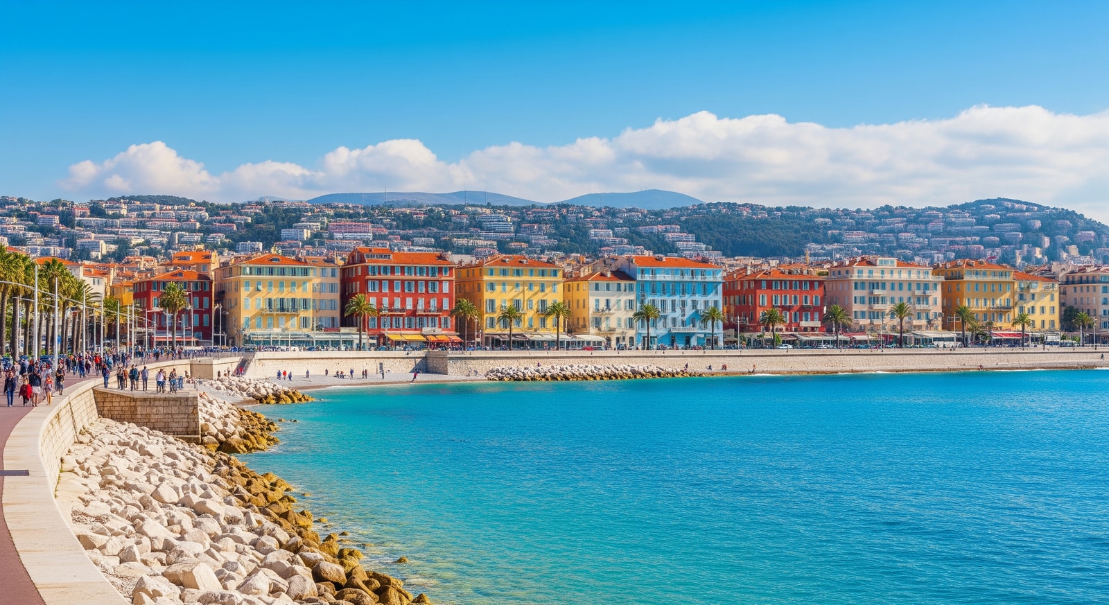 Azure waters of the French Riviera with colorful buildings along the Promenade des Anglais in Nice