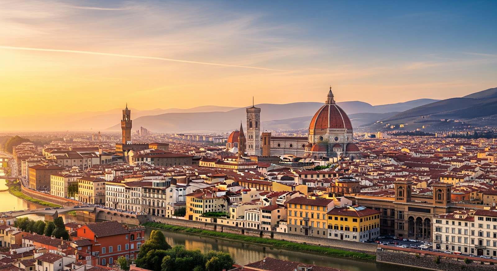 Panoramic view of Florence showing the magnificent Duomo cathedral dome rising above red-tiled rooftops