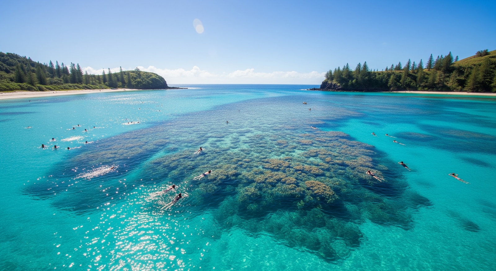 Swimmers enjoying the protected turquoise waters of Emily Bay with reef visible