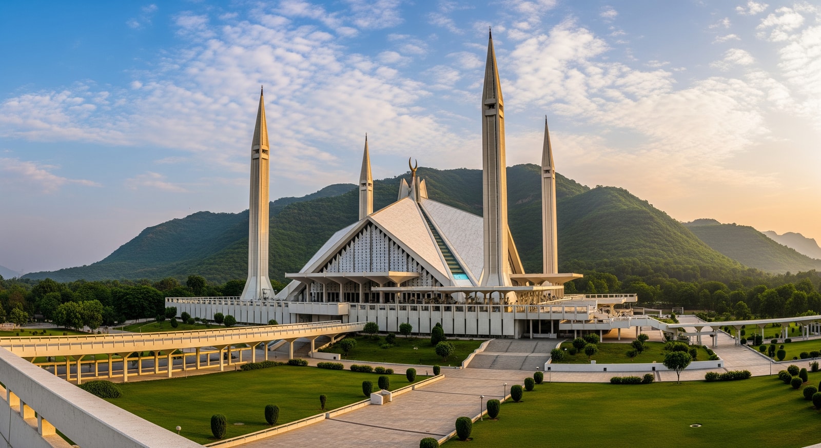 Modern Faisal Mosque in Islamabad with its distinctive triangular architecture against the Margalla Hills