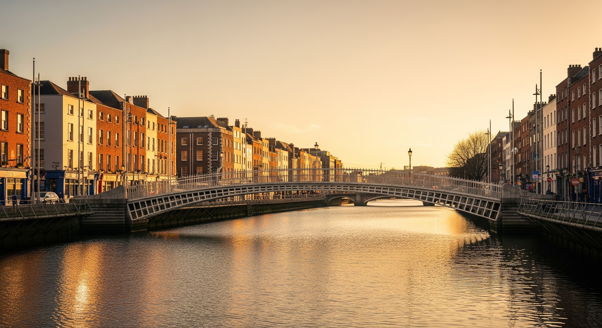 Ha'penny Bridge over the River Liffey in Dublin at golden hour with Georgian architecture representing Ireland's cultural and institutional heritage