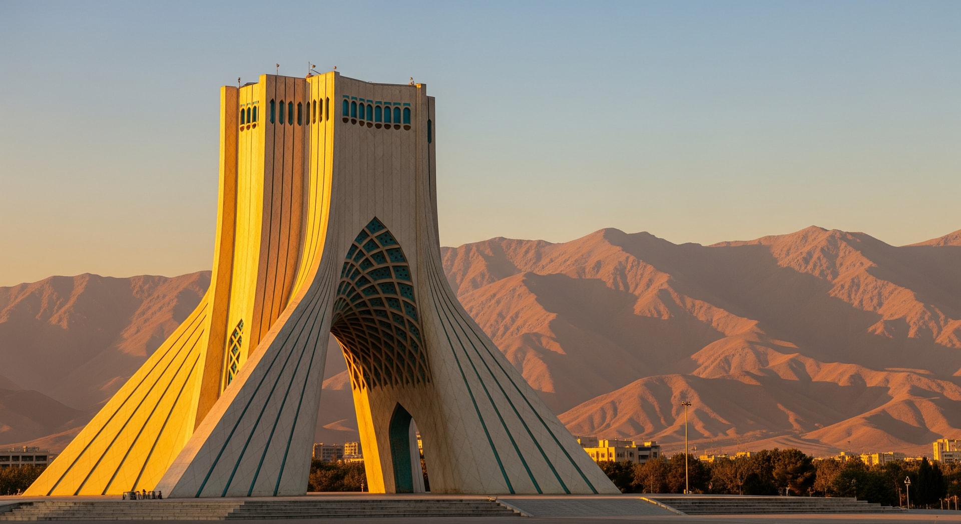 Azadi Tower in Tehran at golden hour with the Alborz Mountains in the background representing Iran's cultural and institutional heritage