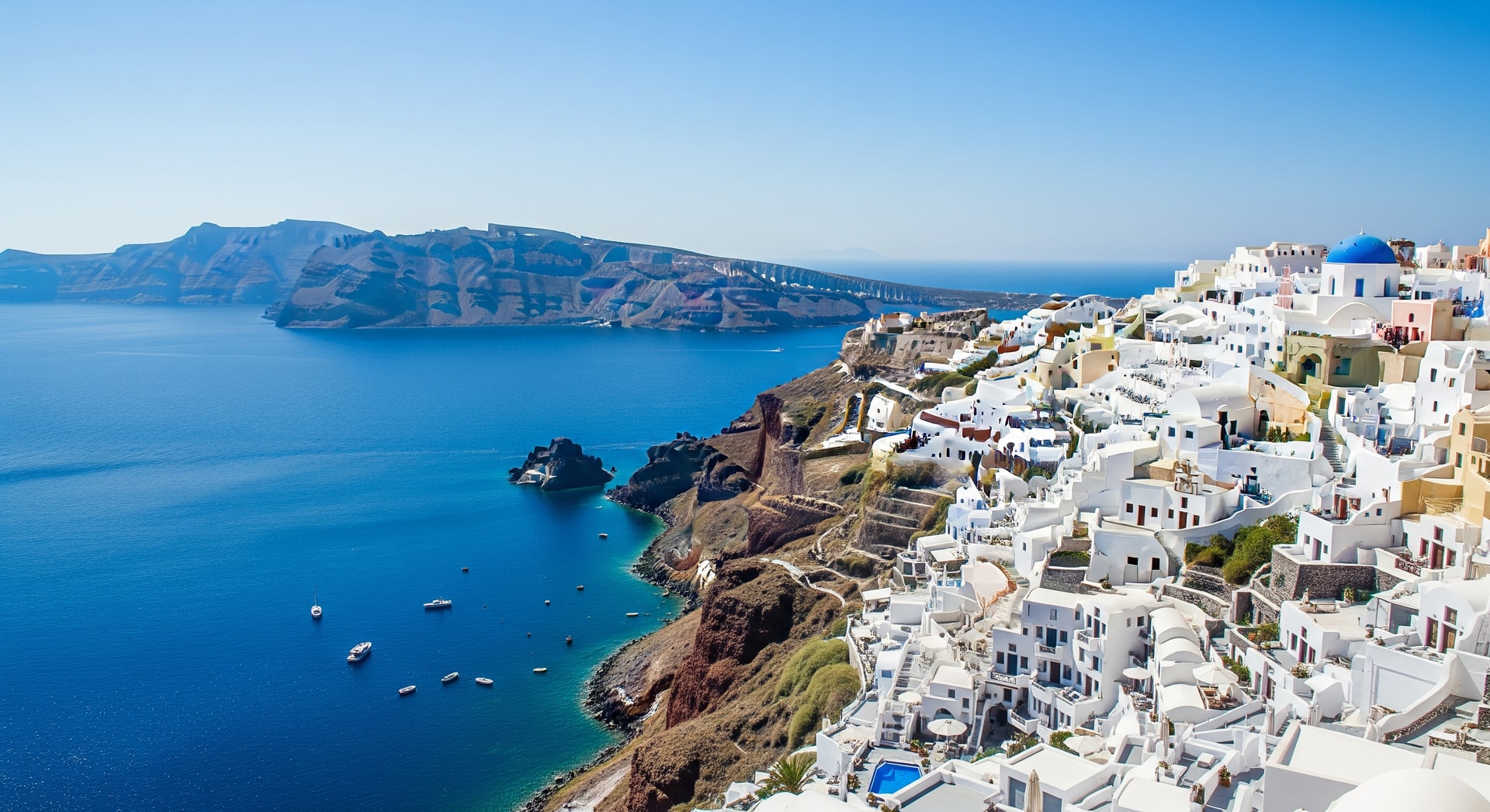 Aerial view of Santorini's caldera with white buildings and blue Aegean Sea
